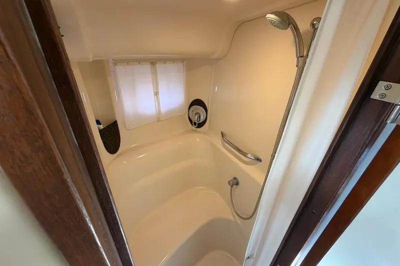 Slide: The Image of Shower area inside 2007 Sea Ray 44 Sundancer yacht, featuring a handheld showerhead and curtain. - 32