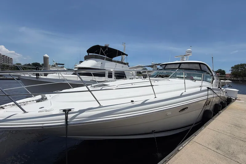 Slide: The Image of 2007 Sea Ray 44 Sundancer yacht docked at marina under clear blue sky. - 4