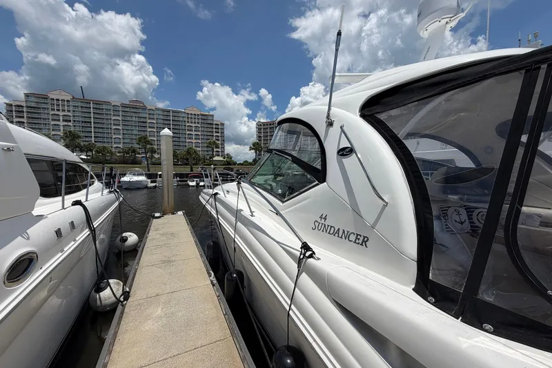 Slide: The Image of 2007 Sea Ray 44 Sundancer yacht docked at marina with cloudy sky backdrop. - 5