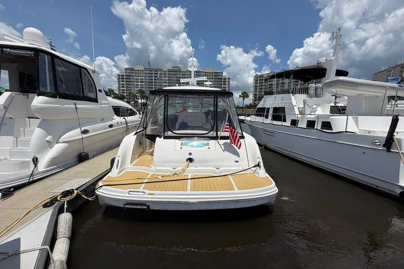 Slide: The Image of 2007 Sea Ray 44 Sundancer yacht docked at marina under a partly cloudy sky. - 6