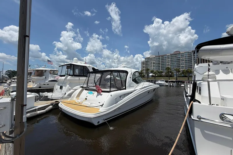 Slide: The Image of 2007 Sea Ray 44 Sundancer yacht docked at marina under blue sky. - 7