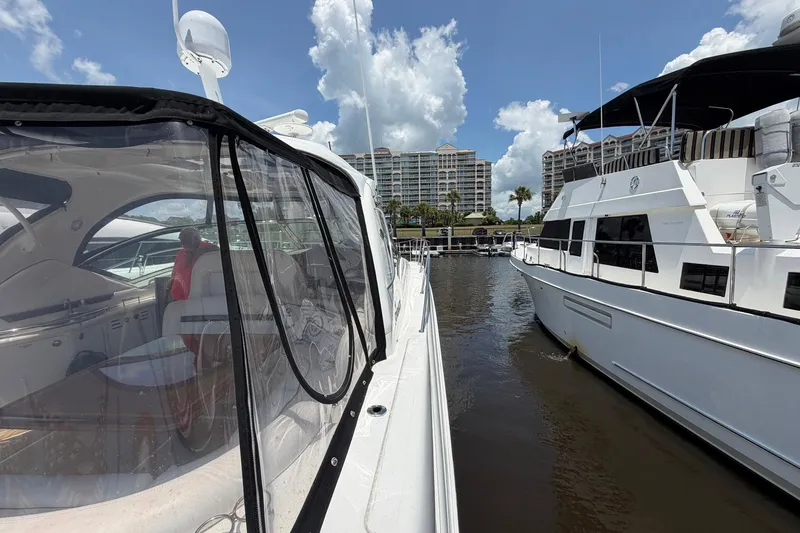 Slide: The Image of 2007 Sea Ray 44 Sundancer yacht docked beside another boat in a marina. - 8