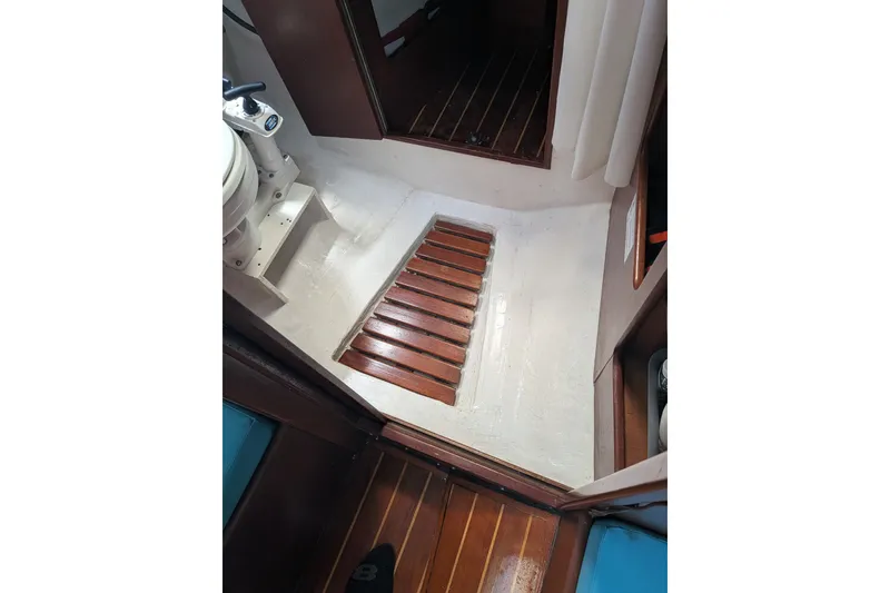 Slide: The Image of Interior of 1978 Hallberg-Rassy Monsun 31 sailboat, featuring wooden flooring and compact design. - 40