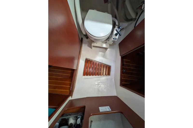 Slide: The Image of Interior of 1978 Hallberg-Rassy Monsun 31 sailboat bathroom with wooden accents. - 43