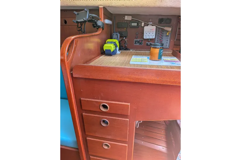 Slide: The Image of Interior of 1978 Hallberg-Rassy Monsun 31 sailboat with navigation equipment and wooden cabinetry. - 33