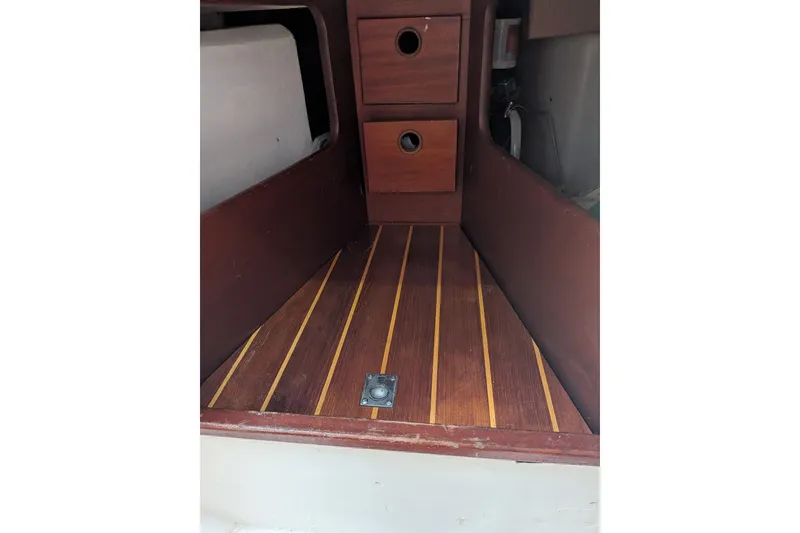Slide: The Image of Interior of 1978 Hallberg-Rassy Monsun 31 sailboat with wooden flooring and storage drawers. - 41