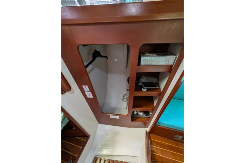 Slide: The Image of Interior of 1978 Hallberg-Rassy Monsun 31 sailboat with wooden cabinetry and storage shelves. - 45