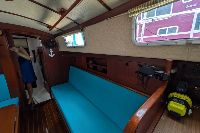 Slide: The Image of Interior of a 1978 Hallberg-Rassy Monsun 31 sailboat with blue seating and wooden accents. - 42
