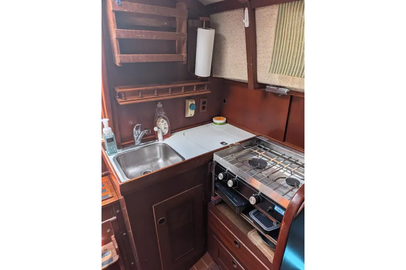 Slide: The Image of Interior of 1978 Hallberg-Rassy Monsun 31 sailboat galley with stove and sink. - 30