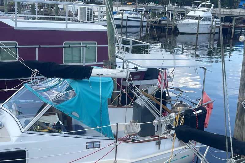 Slide: The Image of 1987 Hallberg-Rassy Monsun 31 sailboat docked at a marina with other boats. - 4
