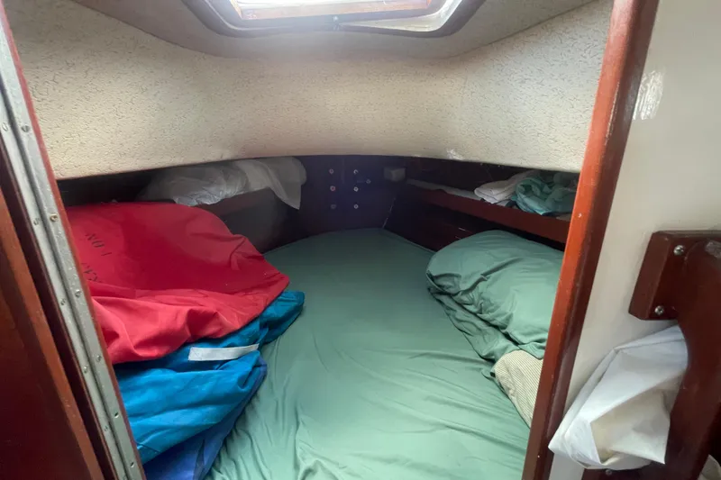 Slide: The Image of Cozy cabin interior of 1987 Hallberg-Rassy Monsun 31 sailboat with bedding and storage. - 16