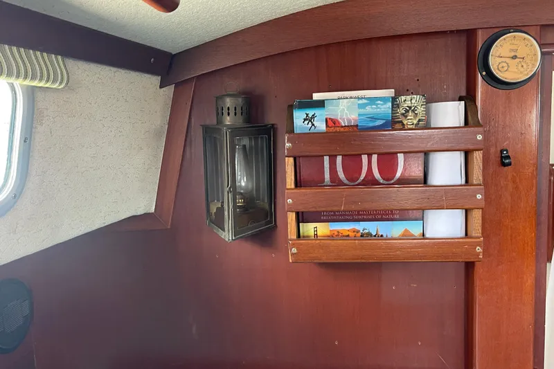 Slide: The Image of Interior of 1987 Hallberg-Rassy Monsun 31 yacht with wooden bookshelf and lantern. - 23