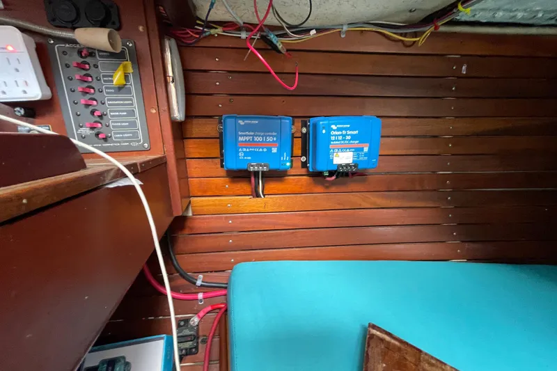 Slide: The Image of Electrical panel and chargers inside a 1987 Hallberg-Rassy Monsun 31 sailboat cabin. - 21