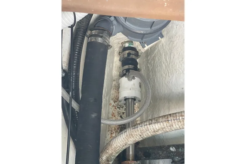 Slide: The Image of Engine compartment of a 1987 Hallberg-Rassy Monsun 31 sailboat, showing hoses and fittings. - 27