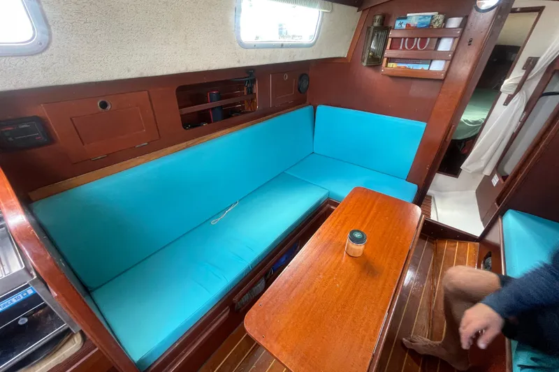 Slide: The Image of Interior of 1987 Hallberg-Rassy Monsun 31 sailboat with turquoise seating and wooden table. - 14