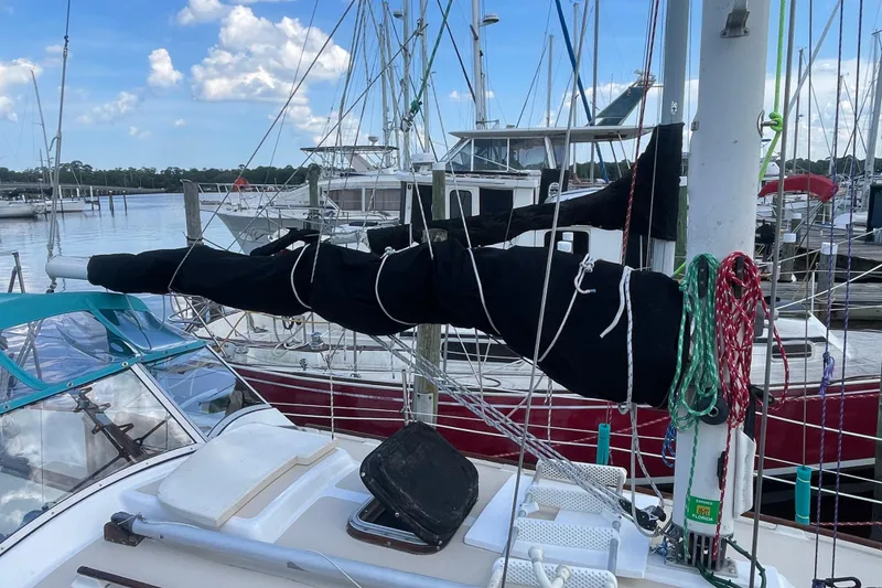 Slide: The Image of 1987 Hallberg-Rassy Monsun 31 sailboat docked at marina with covered boom. - 3