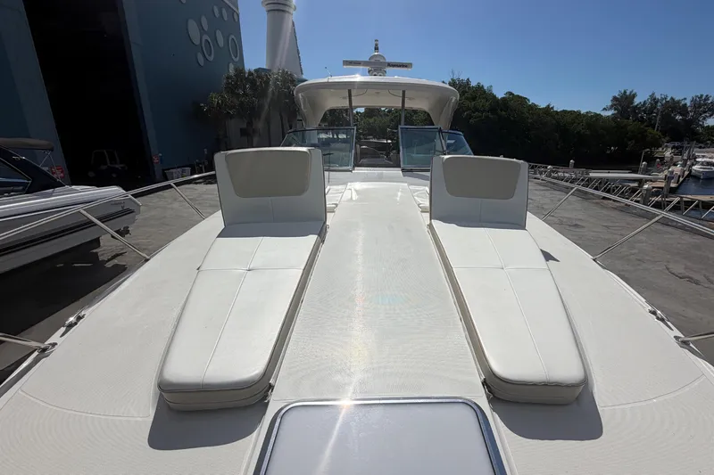 Slide: The Image of 2016 Formula 40 Performance Cruiser with sun loungers, docked near marina and lighthouse. - 13