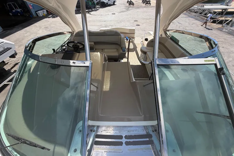 Slide: The Image of 2016 Formula 40 Performance Cruiser interior with seating and helm, docked outdoors. - 14