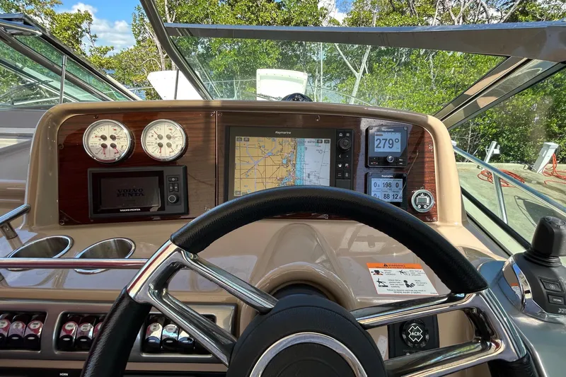 Slide: The Image of The cockpit of a 2016 Performance Cruiser Formula 40 with navigation system and steering wheel. - 21