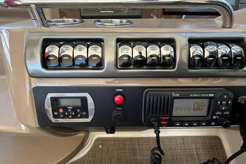 Slide: The Image of Control panel of a 2016 Performance Cruiser Formula 40 with switches and radio equipment. - 27