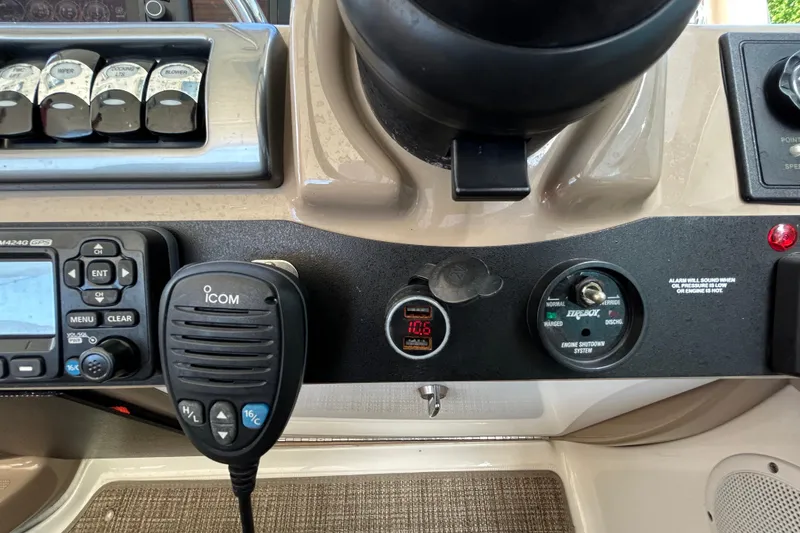 Slide: The Image of Control panel of a 2016 Performance Cruiser Formula 40 with Icom radio and switches. - 30