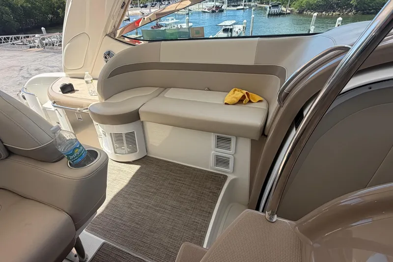 Slide: The Image of Interior of a 2016 Performance Cruiser Formula 40 yacht, featuring plush seating and scenic marina view. - 36