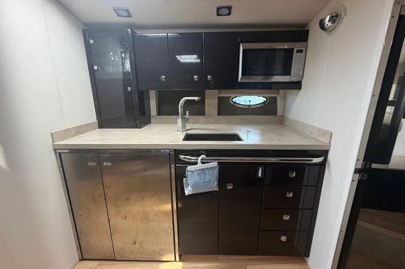 Slide: The Image of Modern kitchen in 2016 Performance Cruiser Formula 40 yacht with sleek cabinetry and appliances. - 52