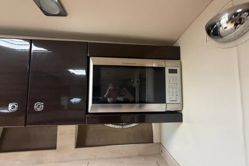 Slide: The Image of Microwave in 2016 Performance Cruiser Formula 40 yacht kitchen, with sleek dark cabinetry. - 55