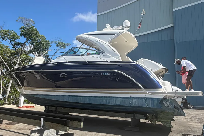 Slide: The Image of 2016 Formula 40 Performance Cruiser on dry dock, undergoing maintenance near a large building. - 7