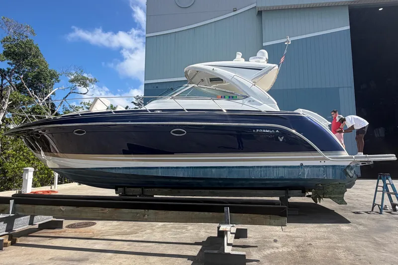 Slide: The Image of 2016 Formula 40 Performance Cruiser on dry dock, with people inspecting it. - 8