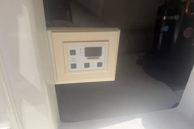 Slide: The Image of Control panel inside a 2016 Performance Cruiser Formula 40 boat, featuring digital display and buttons. - 81