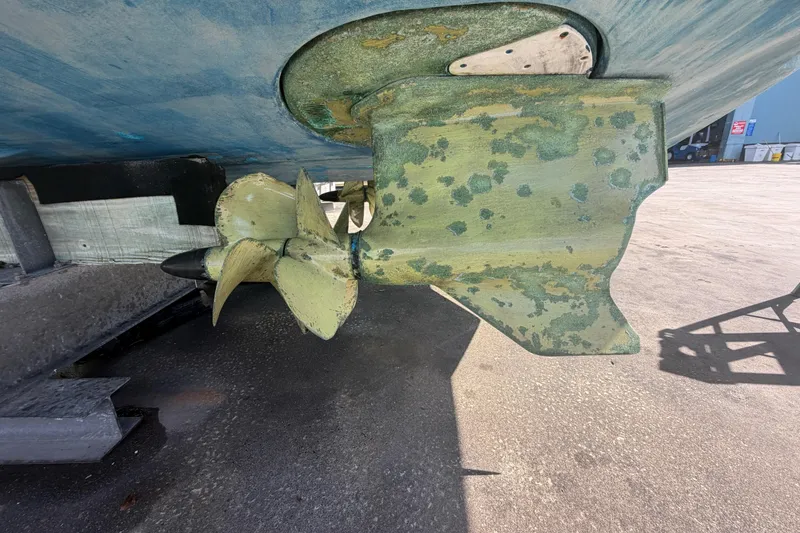 Slide: The Image of Propeller and rudder of a 2016 Performance Cruiser Formula 40, showing wear and marine growth. - 88