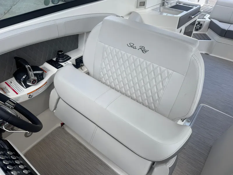 Slide: The Image of Interior of a 2025 Sea Ray SLX 350 with elegant white seating and modern controls. - 16