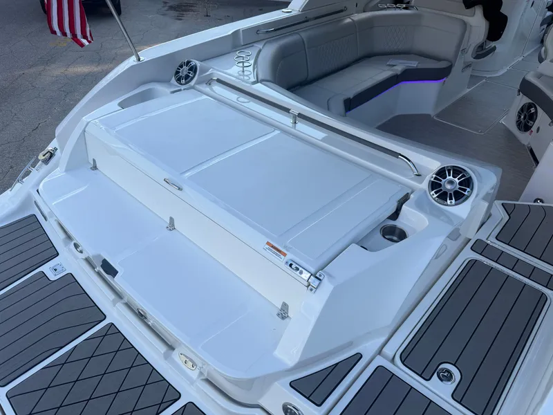 Slide: The Image of The image shows the rear of a 2025 Sea Ray SLX 350 boat with a spacious sun pad and sleek seating. - 31