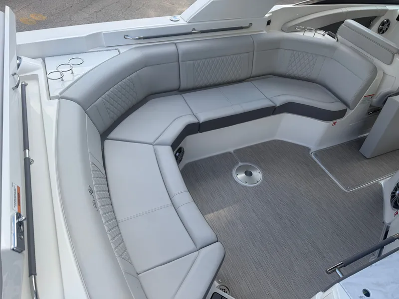 Slide: The Image of The image shows the seating area of a 2025 Sea Ray SLX 350 boat with gray upholstery. - 11