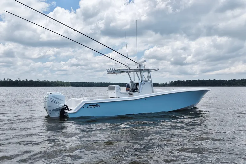 Slide: The Image of 2008 Invincible 33 Open Fisherman boat on calm water under cloudy sky. - 10