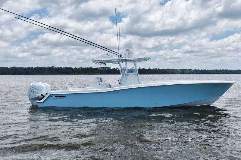 Slide: The Image of 2008 Invincible 33 Open Fisherman boat on calm water under cloudy sky. - 11