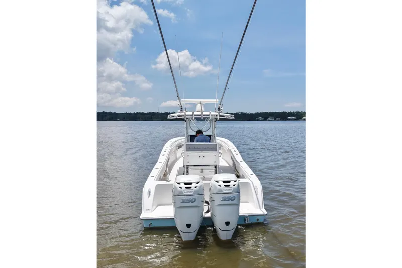 Slide: The Image of 2008 Invincible 33 Open Fisherman boat with twin engines on calm water. - 12