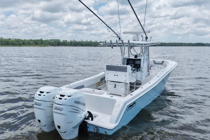 Slide: The Image of 2008 Invincible 33 Open Fisherman boat with twin Mercury 350 engines on a calm lake. - 16