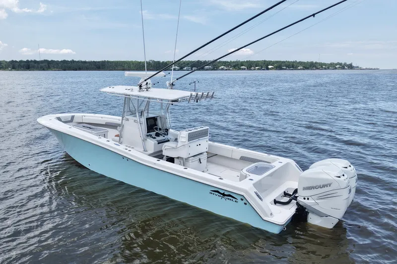 Slide: The Image of 2008 Invincible 33 Open Fisherman boat on calm water, featuring twin Mercury engines. - 17