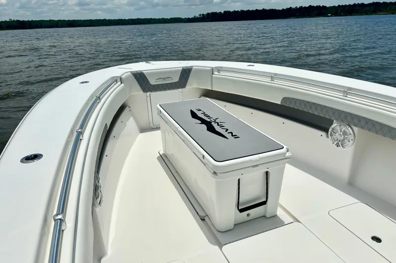 Slide: The Image of 2008 Invincible 33 Open Fisherman boat interior with seating and storage on calm water. - 18