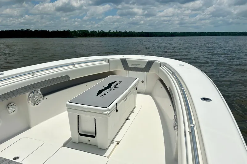 Slide: The Image of 2008 Invincible 33 Open Fisherman boat on calm water under cloudy sky. - 19