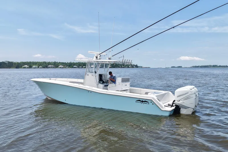 Slide: The Image of 2008 Invincible 33 Open Fisherman boat on calm water, featuring twin Mercury engines. - 2