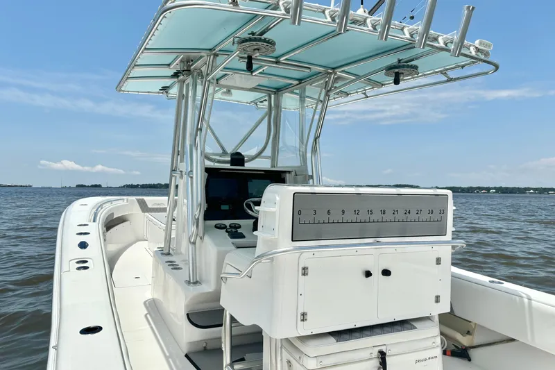 Slide: The Image of 2008 Invincible 33 Open Fisherman boat on calm waters, featuring a sleek center console design. - 23