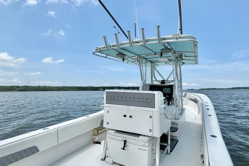 Slide: The Image of 2008 Invincible 33 Open Fisherman boat on calm water under blue sky. - 24