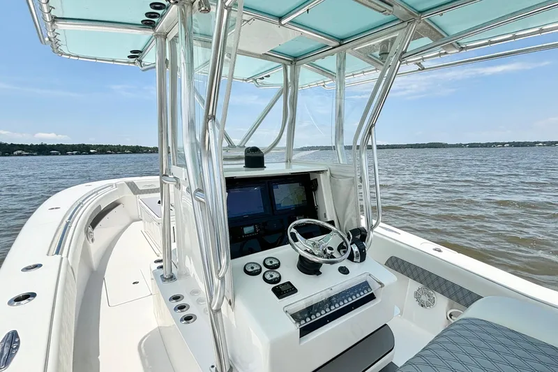 Slide: The Image of 2008 Invincible 33 Open Fisherman boat interior with steering console on open water. - 26