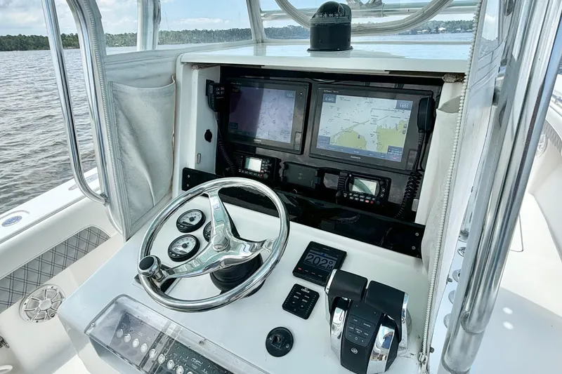 Slide: The Image of Center console of 2008 Invincible 33 Open Fisherman with navigation screens and controls. - 27
