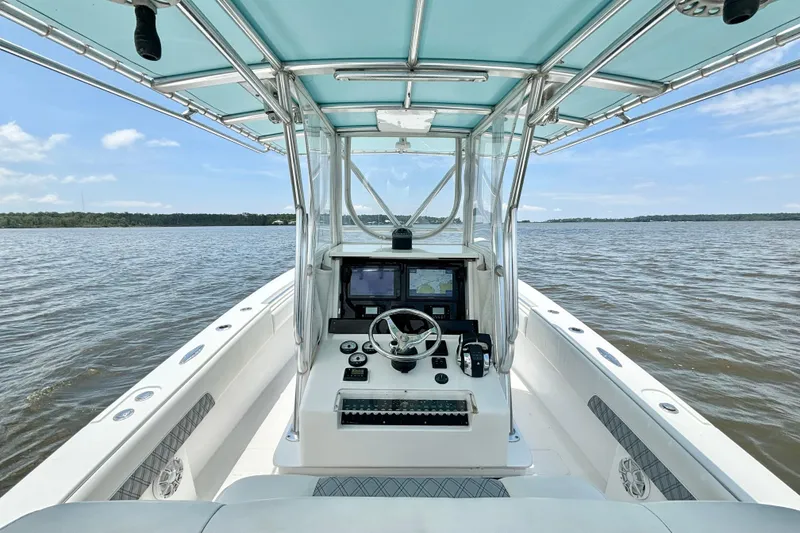Slide: The Image of 2008 Invincible 33 Open Fisherman boat on calm waters, featuring a modern helm station. - 28