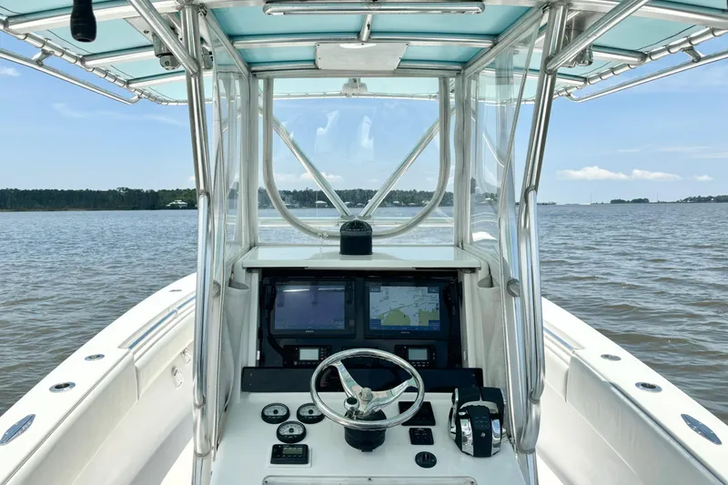 Slide: The Image of 2008 Invincible 33 Open Fisherman boat dashboard with navigation screens on calm water. - 29