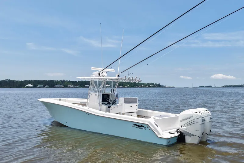 Slide: The Image of 2008 Invincible 33 Open Fisherman boat on calm water, featuring twin Mercury engines. - 3